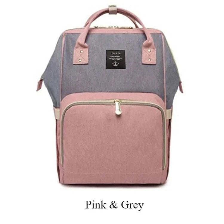 Fashion maternity nappy bag in pink and grey with spacious compartments.