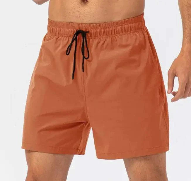 Loose Fitness Casual Running Shorts in orange with drawstring waistband and pockets.