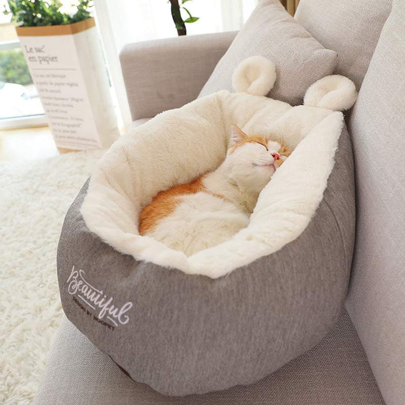 Pet dog bed warming soft sleeping bag with cat inside, cotton material, grey color, sofa setting.