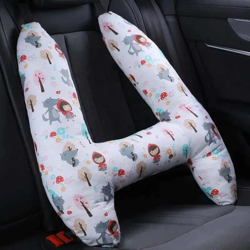 Kids car travel pillow with ergonomic neck support in a colorful design placed on a car seat.