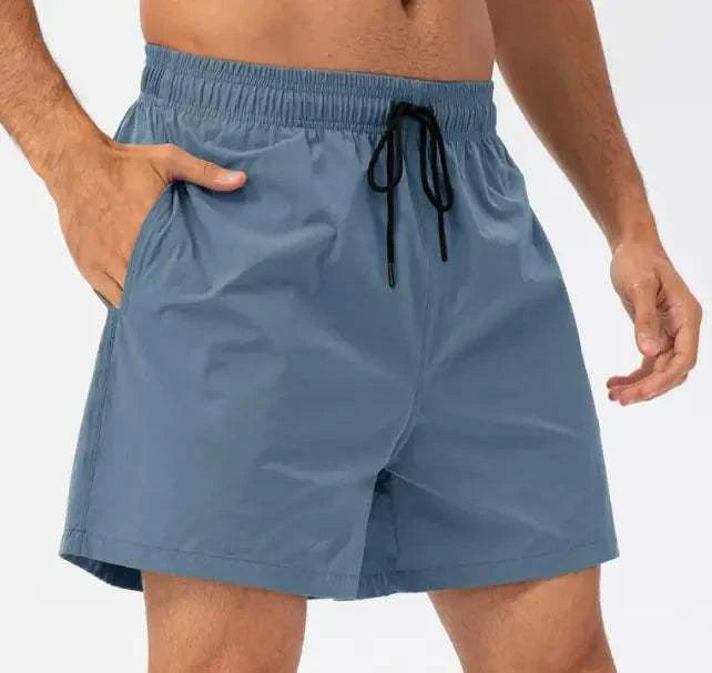 Blue casual running shorts with an adjustable waistband, side pockets, and a relaxed fit for comfort and style.