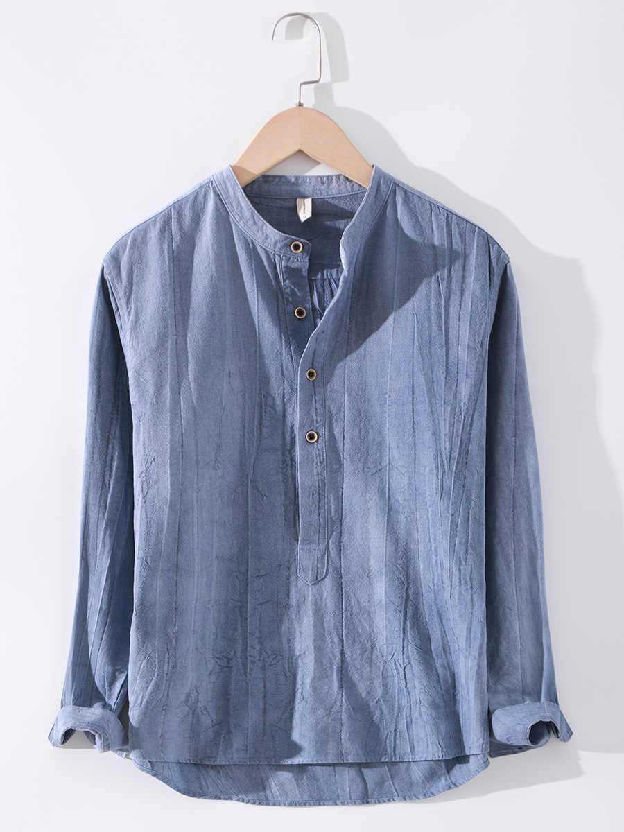 Linen shirt long sleeved stand up collar retro top in light blue on hanger.