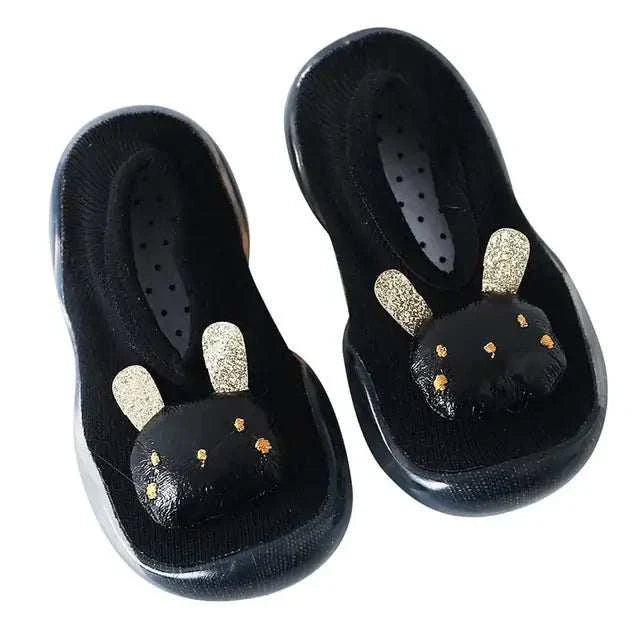 Black toddler shoes with anti-slip soles, featuring gold-accented bunny ears, designed for style and comfort.