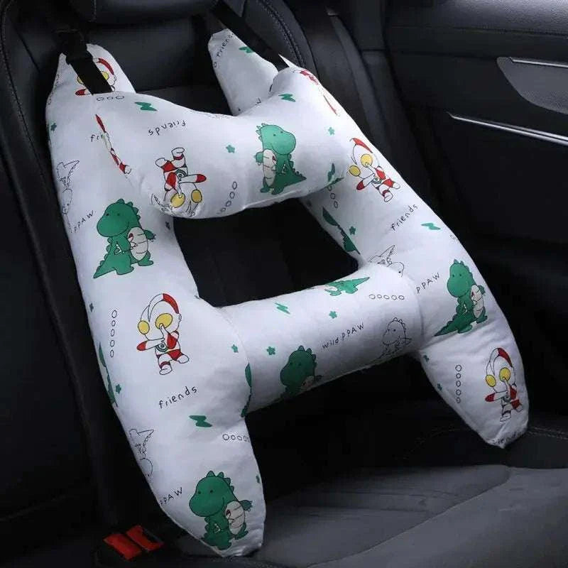 Kids car travel pillow with dinosaur design on a car seat.