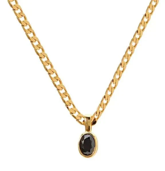 Gold chain necklace with an oval black crystal pendant.