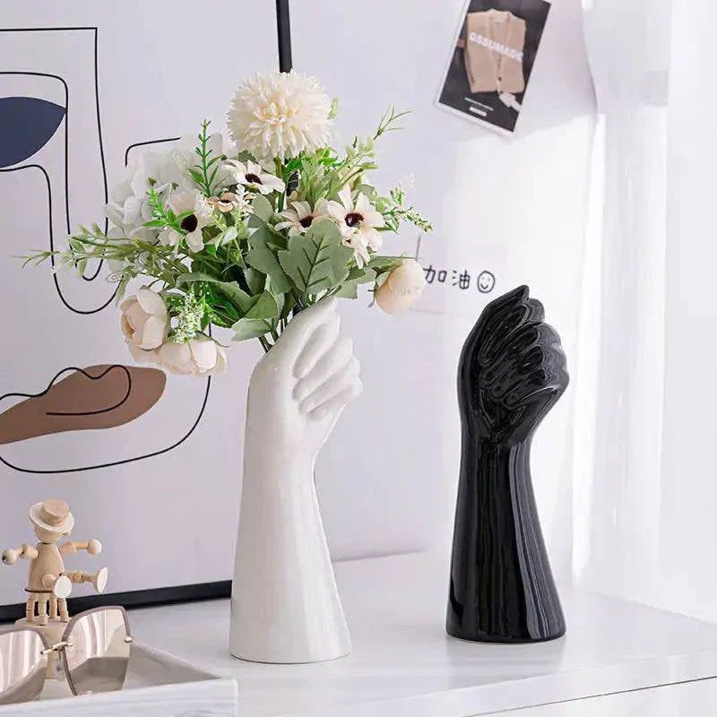 Artistic Ceramic Hand Vase in black and white on a decorative tabletop.