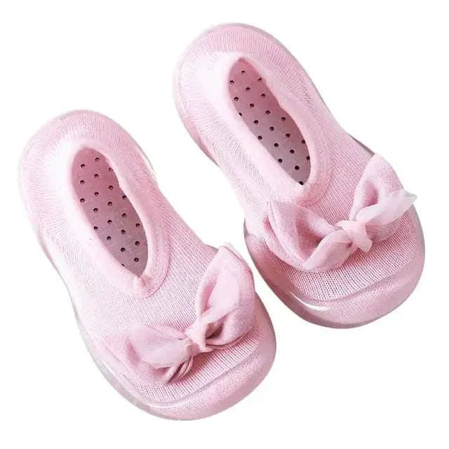 Pink toddler shoes with bows and anti-slip soles.