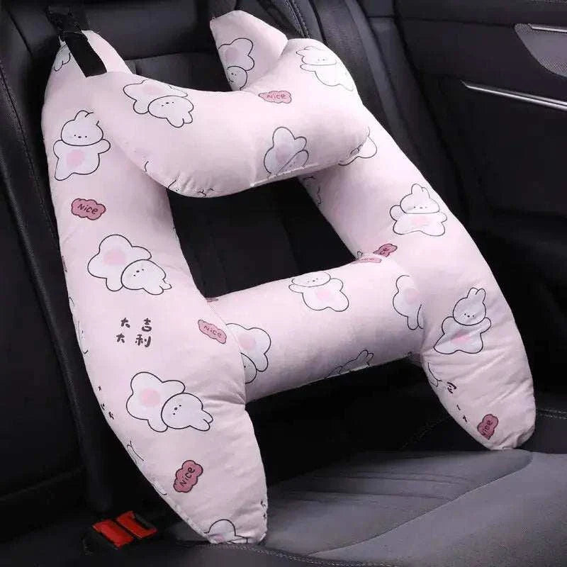 Kids car travel pillow with cute design, providing neck support in a car seat.