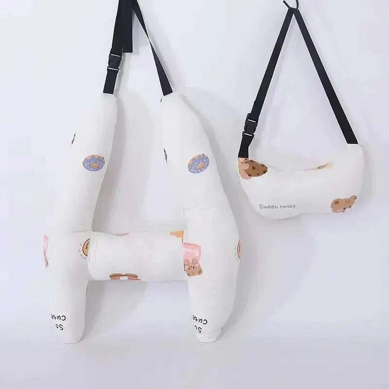 Kids car travel pillow hanging on a wall with cute bear designs.