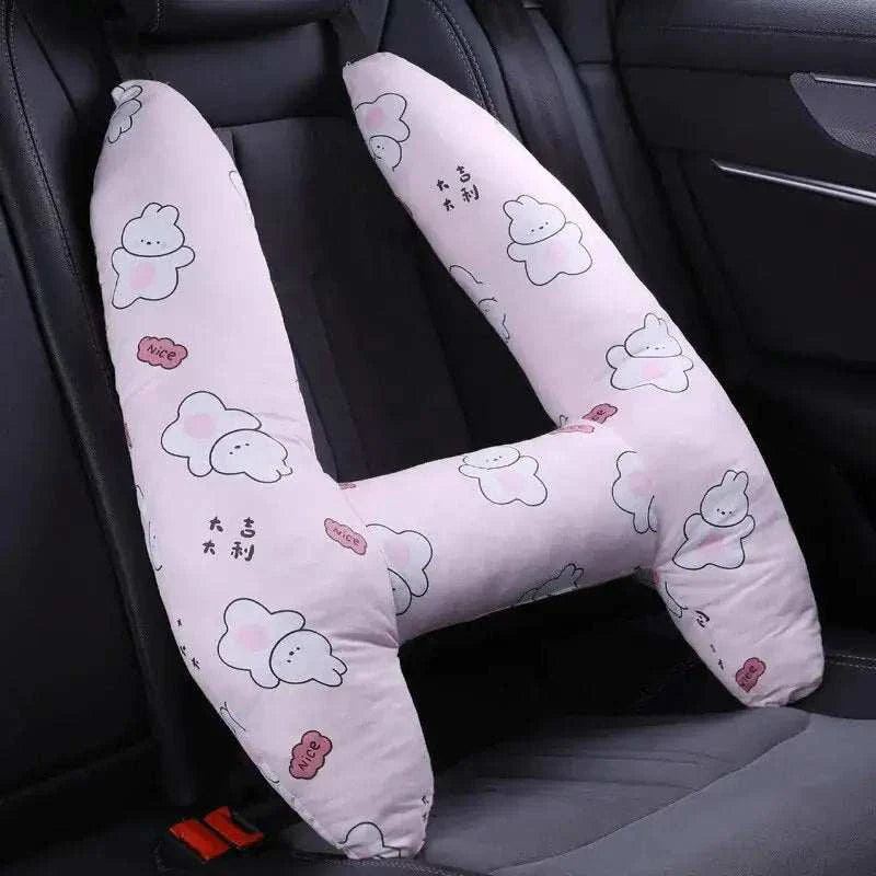 Kids car travel pillow with cute cartoon print on car seat.