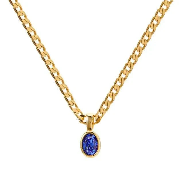 Gold chain necklace with an oval blue crystal stone pendant.