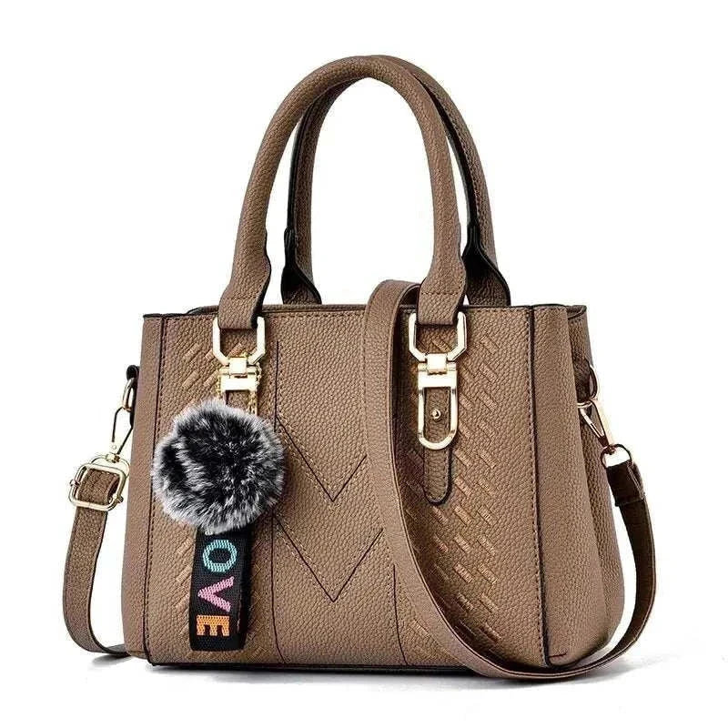 Embroidery messenger bag for women, bucket shape, brown with strap and pom-pom accessory. Perfect handbag for everyday use.