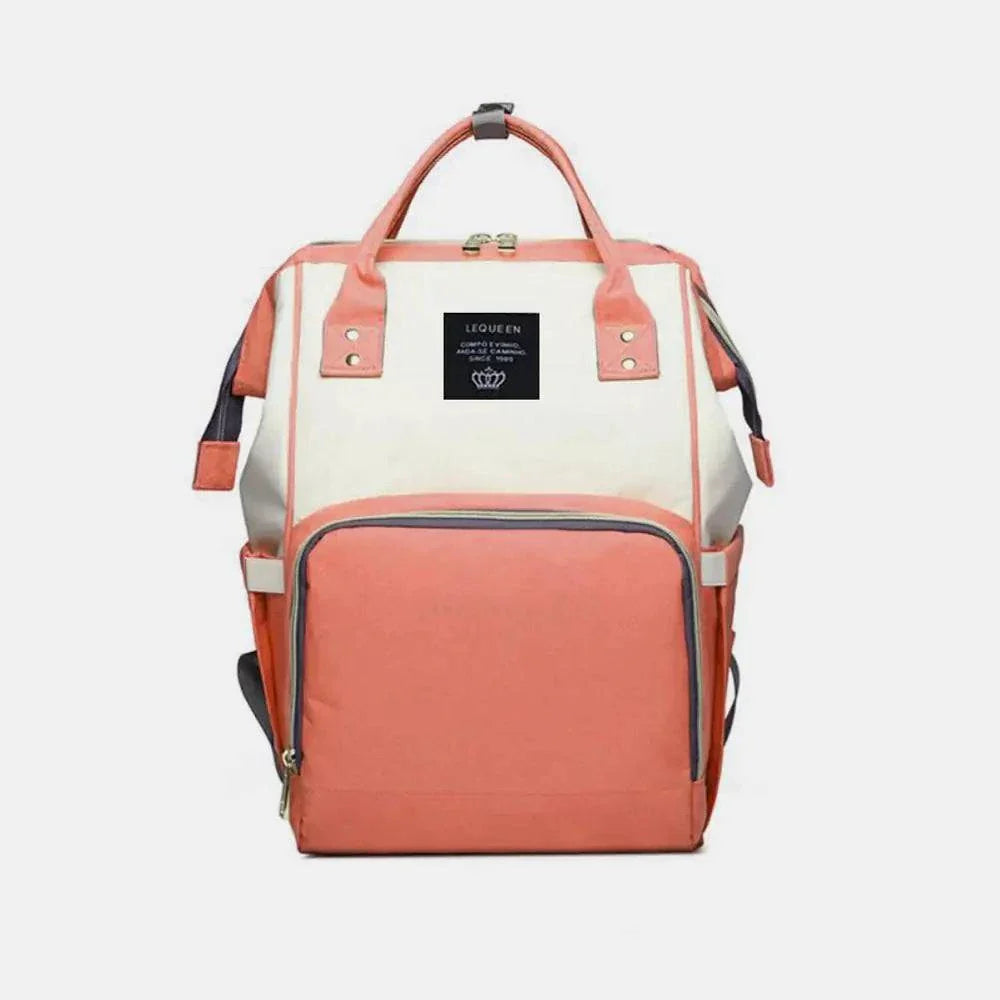 Stylish peach and cream Fashion Maternity Nappy Bag with spacious compartments and durable design.