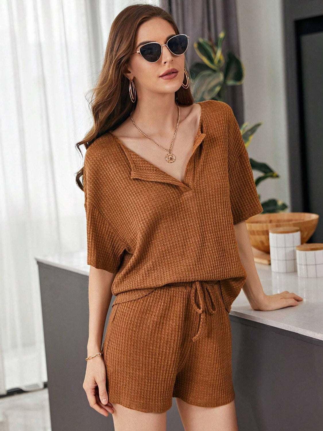 Full Size Waffle-Knit Dropped Shoulder TopExpress Global Mart  Features: Tied, Waffle-Knit
Number of pieces: Two-piece
Stretch: Slightly stretchy
Material composition: 100% polyester
Care instructions: Machine wash cold. Tumble Full Size Waffle-Knit Dropped Shoulder Top and Shorts SetTrendsi