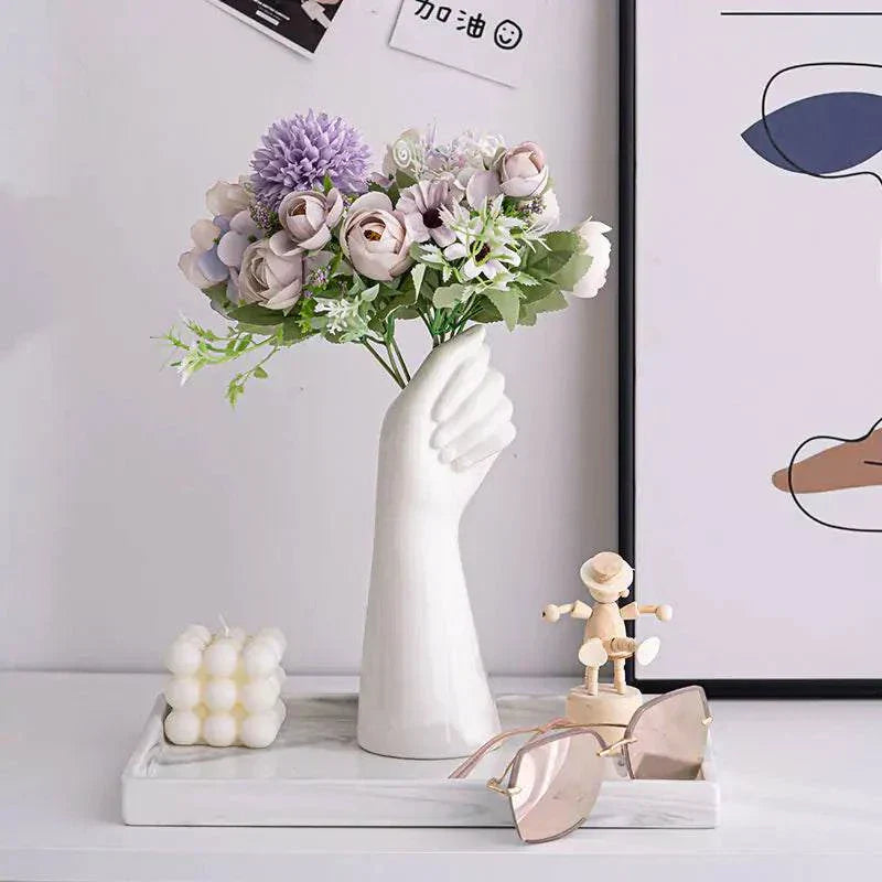 Artistic Ceramic Hand Vase with flowers on a tabletop, showcasing unique home decor style.