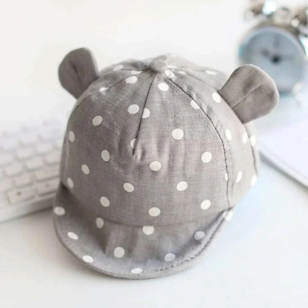 Toddler sun hat with cute dots, ear coverage, and soft fabric for sun protection.