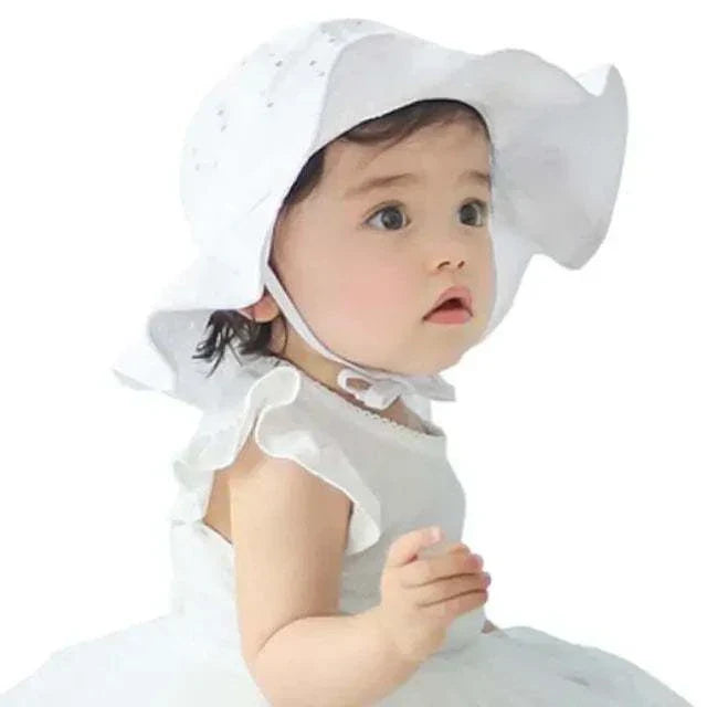 Toddler wearing a white Lovely Toddler Kids Hat with ear coverage, suitable for ages 1-3.