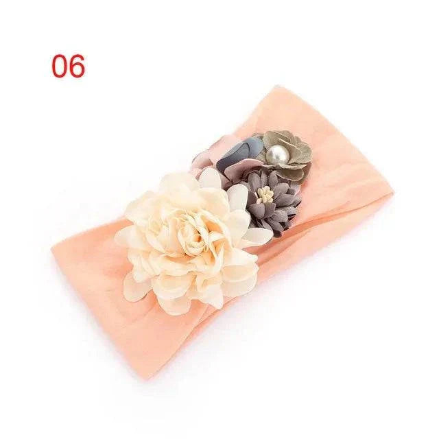 Toddler girls kid baby bow hairband with 3D flower, soft elastic, and elegant design in peach color.