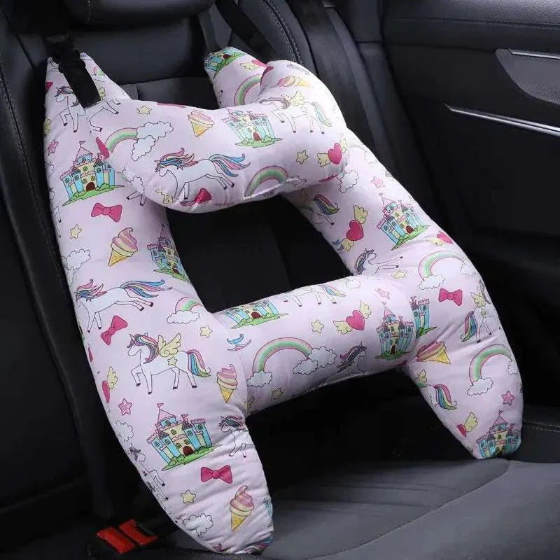 kids car travel pillow with unicorn print in car seat for support and comfort